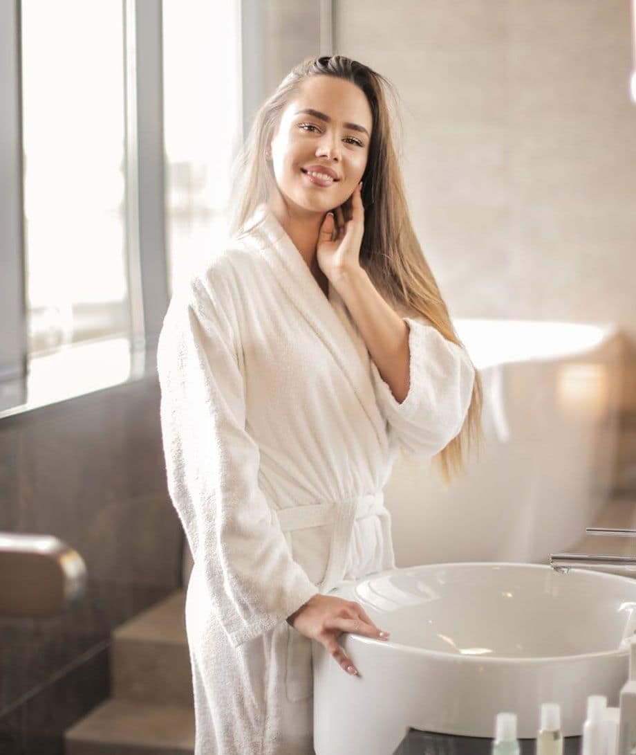 Woman in Gown Standing in Bathroom Woman in Gown Standing in Bathroom